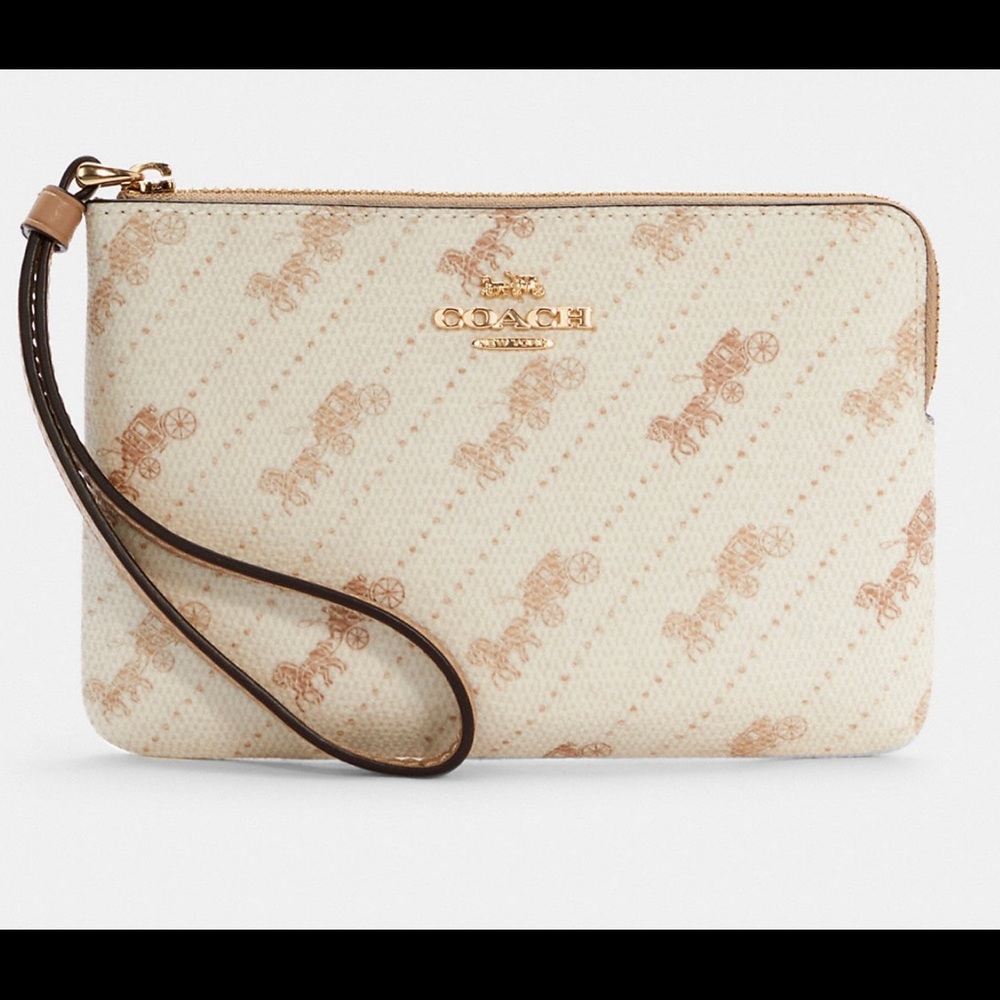 Coach corner zip wristlet with horse and carriage dot print.
